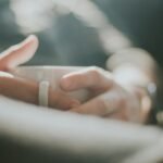 selective focus photography of person holding white mug